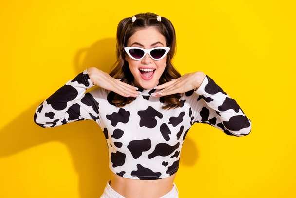 Photo of positive crazy cowgirl in sunglass spotted clothes enjoy incredible travel sales isolated vivid color background. - Foto, imagen