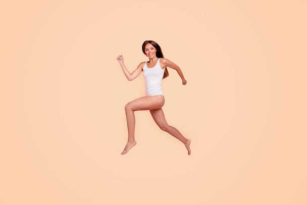 Full length size body young gorgeous nice straight-haired funny lady wearing sleepwear, hurry running in air. Isolated over pink pastel background. - Foto, afbeelding