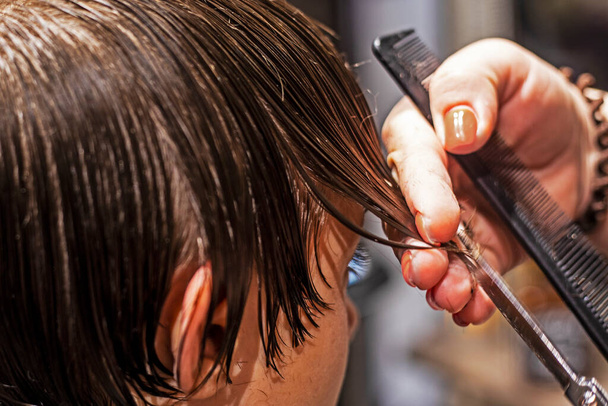 barbershop cuts under the knife the tips of wet clean hair - Photo, Image