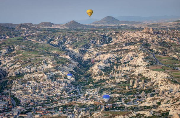 A beautiful shot of the hot air balloons over a landscape in the Cappadocia area in Turkey - Foto, immagini