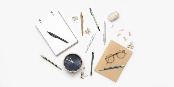 Set of school supplies with alarm clock and eyeglasses on white background - 写真・画像