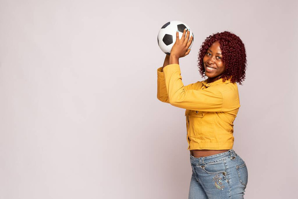 young black lady playing with a football - Foto, imagen