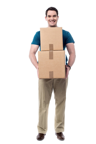 Чоловік тримає купу коробок
 - Фото, зображення