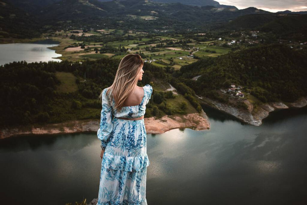 A caucasian female model in the mountains enjoying the view - 写真・画像