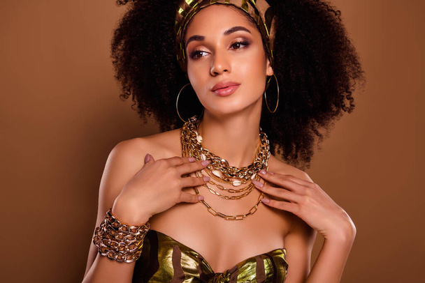 Photo of rich egyptian queen lady wear gold chain necklace for native theme party festival on brown color background. - Photo, Image
