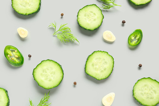 Slices of cucumber with dill and chilli on grey background - Photo, Image
