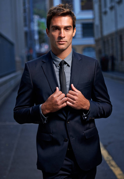 Serious style in the city. A handsome young businessman wearing his suit outside - Foto, imagen