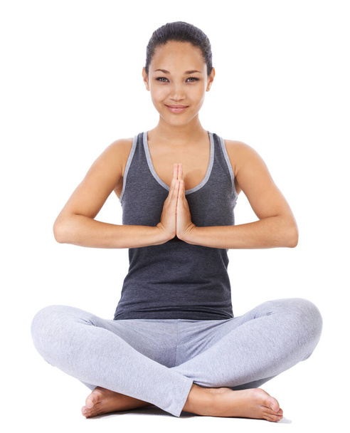 Focussing on fitness. A beautiful young woman doing a yoga pose against a white background - Foto, Imagen