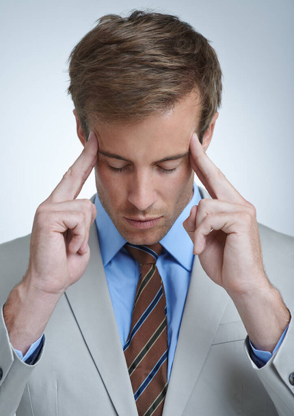 Feeling a bit stressed. a stressed businessman touching his temples - Foto, immagini