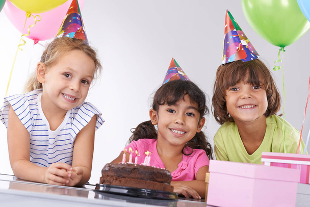 They grow up so fast...Portrait of three smiling friends at a birthday party - Foto, imagen