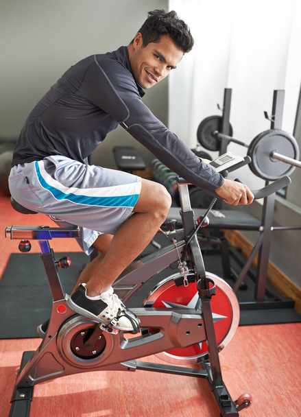 Hes always in the gym. A young ethnic man exercising in the gym - Photo, Image