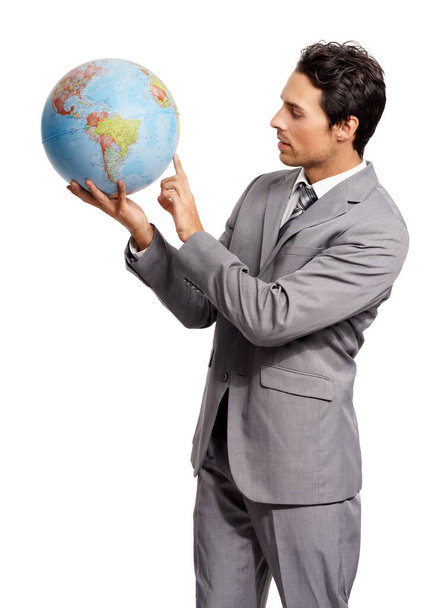 Where to next. A young executive pointing out something on a world globe - isolated - Φωτογραφία, εικόνα