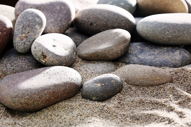 Gray sea pebbles on sand background - Foto, Imagen