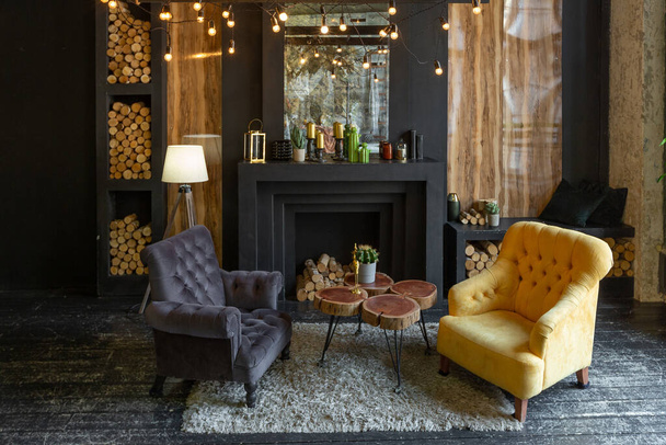 dark brutal interior of sitting room decorated with wooden logs. yellow and grey soft armchairs, huge arc window and fireplace - Fotoğraf, Görsel