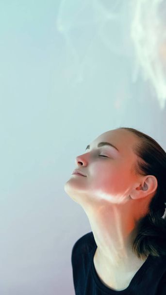 Enjoying moment. Feeling relief. Peaceful woman. Profile portrait calm relaxing light flare girl taking breath on glowing copy space background. - Foto, Imagen