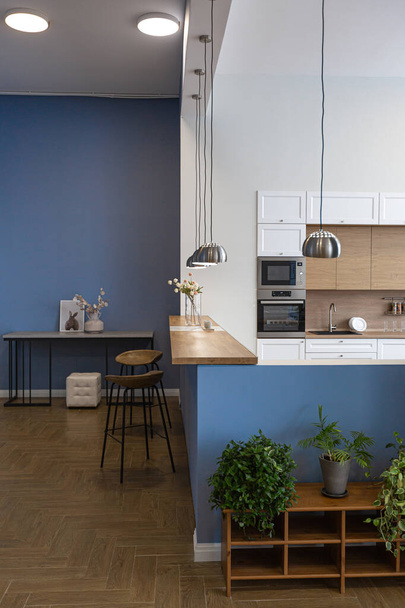 minimalist modern interior design huge bright apartment with an open plan in Scandinavian style in white, blue and dark blue colors with columns in the center. includes kitchen area, office and lounge - Fotografie, Obrázek