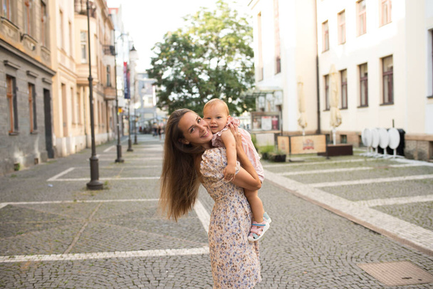 woman with kid in the street of beautiful old town  - Foto, Imagem