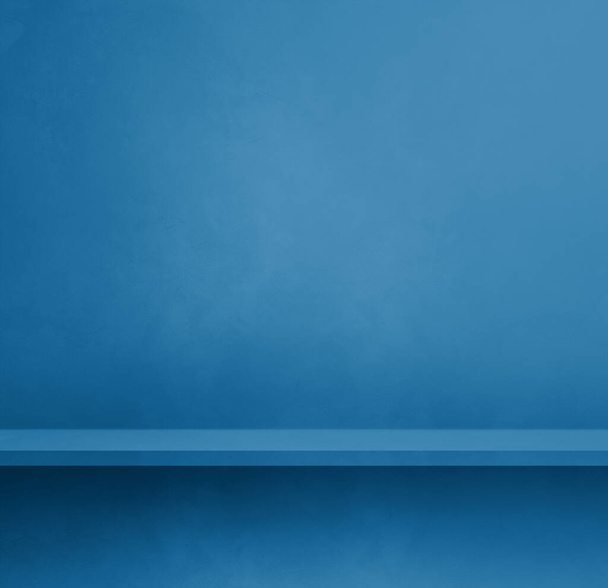 Empty shelf on a blue concrete wall. Background template scene. Square mockup - Photo, image