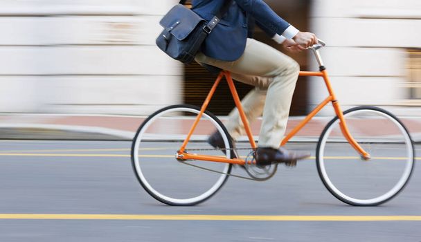 Bicycle, travel and legs of business man in a road riding to work or appointment in n a street. Carbon footprint, cycling and shoes of male on bike traveling in a city on eco friendly transportation. - Photo, image