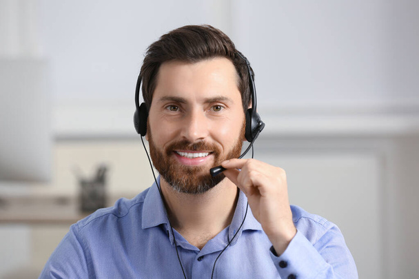 Hotline operator with headset working in office - Foto, afbeelding