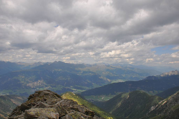 A beautiful landscape of big mountains of the Alps in Italy under the cloudy sky during the daytime - 写真・画像