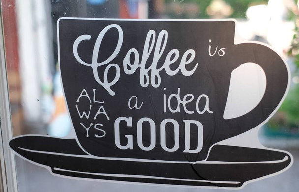 A closeup shot of the ad sticker with coffee is a good idea text - Photo, Image