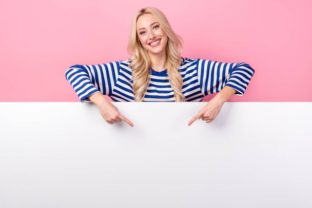 Photo of young promoter targetologist girl wear striped stylish shirt direct fingers empty space buy gym subscription isolated on pink color background. - Zdjęcie, obraz