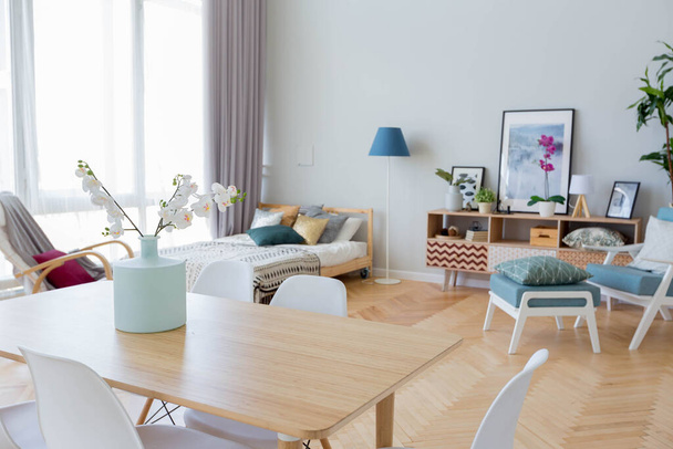 The interior design of the studio apartment in Scandinavian style. A spacious huge room in light colors. stylish expensive luxury furniture. - Φωτογραφία, εικόνα