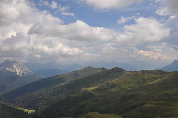 A beautiful landscape of big mountains of the Alps in Italy under the cloudy sky during the daytime - Fotó, kép