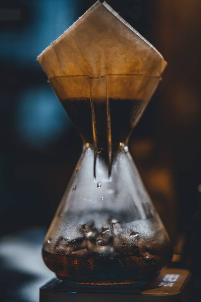 A vertical shot of a Cup Glass Handle with a tea packet on it and steam in it - Fotoğraf, Görsel