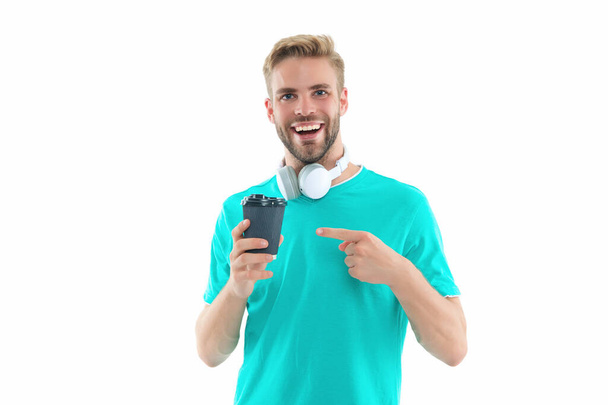 millennial guy with coffee in studio, pointing finger. photo of millennial guy with coffee. millennial guy with coffee isolated on white. millennial guy with coffee on background. - Foto, imagen