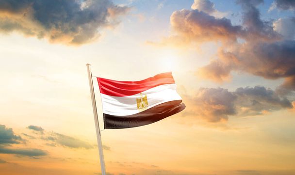 Egypte zwaaiende vlag in prachtige hemel met wolken en zon - Foto, afbeelding