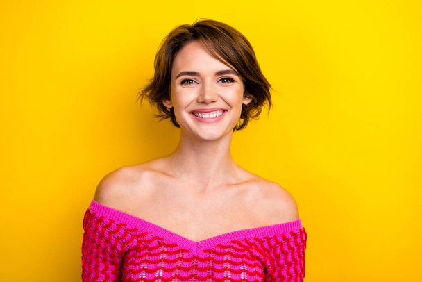 Portrait of adorable gorgeous woman with short haircut wear pink dress toothy smiling at camera isolated on yellow color background. - Foto, Imagem