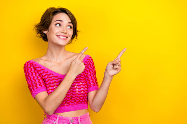 Portrait of positive lovely adorable lady wear trendy outfit promoting new store mall empty space isolated on yellow color background. - Фото, зображення