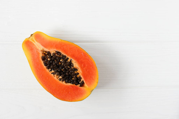 Papaya fruit, raw ripe on white wooden background - Foto, immagini