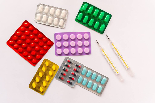 Various medical equipment, thermometer, ampoules, pipette, drugs, tablets, capsules, spray, patch, syringe, vials on a white background. Medicine, - Foto, immagini