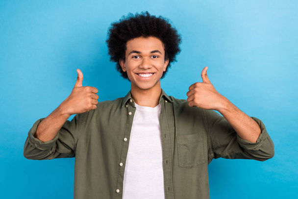 Portrait of positive man hands fingers demonstrate thumb up approval isolated on blue color background. - Foto, Imagen