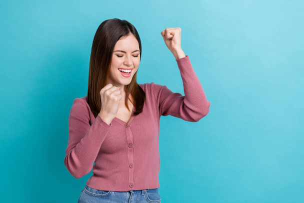 Portrait of optimistic satisfied woman stylish hairstyle wear pink shirt clenching fists win lottery isolated on blue color background. - Zdjęcie, obraz