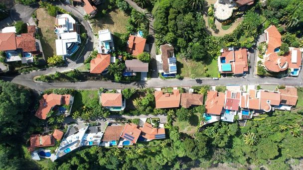 An aerial view of villas in sunlight surrounded with green trees - Fotoğraf, Görsel