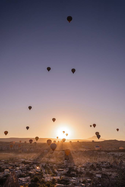 A vertical shot of beautiful hot air balloons at sunset in Cappadocia, Turkiye - Fotografie, Obrázek