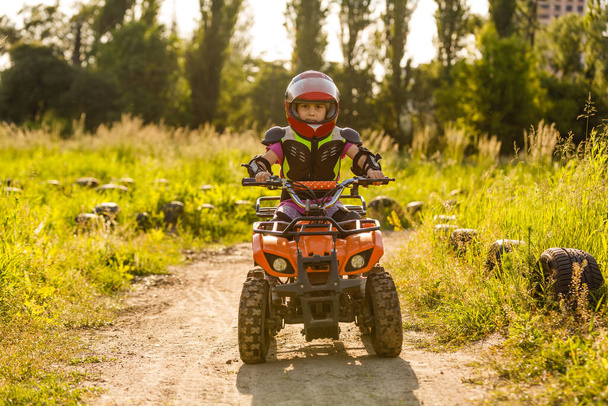 Küçük kız yarış pisti ATV quad bisiklet sürme - Fotoğraf, Görsel