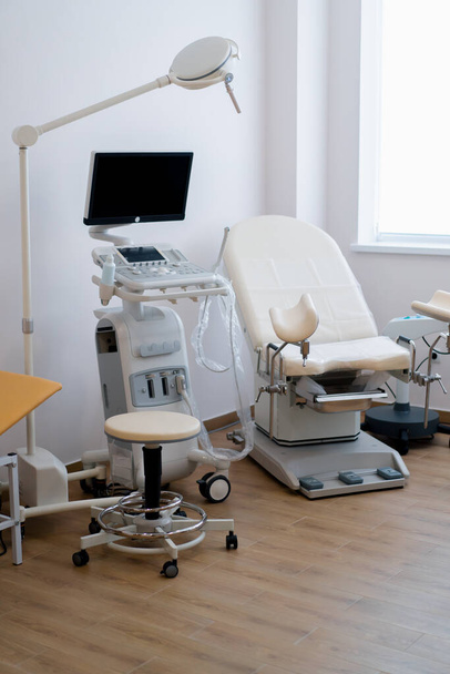 Medical office with ultrasound diagnostic equipment in the gynecological office of clinic gynecological chair - Photo, Image