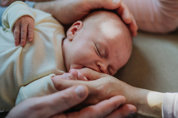 Close-up of parents cuddling their newborn crying son. - Valokuva, kuva