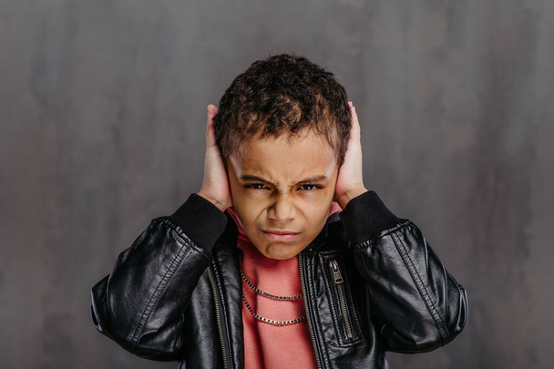 Portrait of little multiracial boy in a leather jacket. - Photo, image