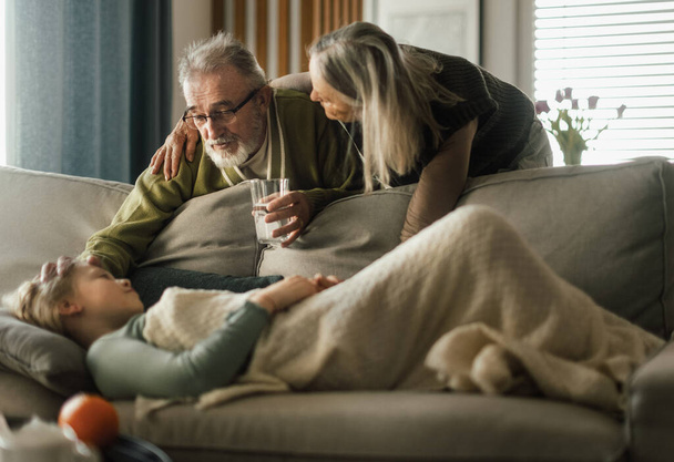 Grandparents taking care of little sick granddaughter. - Photo, image