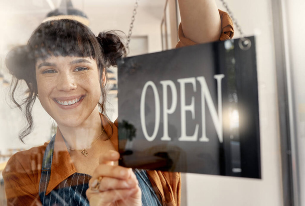 Happiest being an independent woman. a young business owner hanging up an open for business sign - Photo, Image