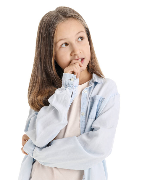 Little girl biting nails on white background - Фото, изображение