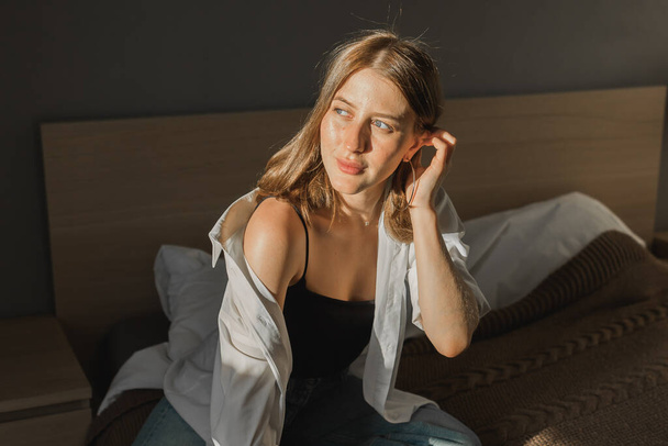 Happy young woman sit relaxing in comfortable chair feel peaceful enjoy sun near big windows. and smiling girl lying with eyes closed rest calm sunny morning at home. - Foto, Imagen