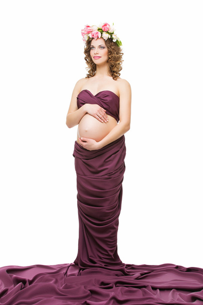 Pregnant woman in fabric - Фото, зображення