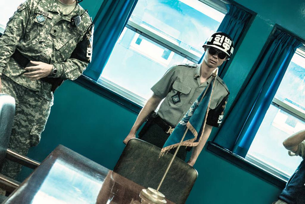 Seoul, South Korea - June 17, 2010 : Both american and South Korean soldiers stands guard within one of the blue conference rooms. The armistice village of panmunjon is controlled by the united - Photo, Image